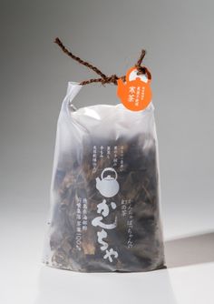 a bag of dried tea sitting on top of a white table