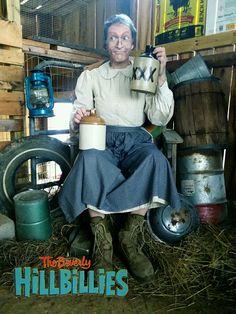 an old woman sitting in a chair holding a coffee mug with the words hillbillies on it