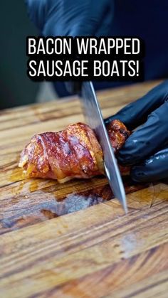 bacon wrapped sausage boats on a wooden cutting board with black gloves and a knife in the foreground