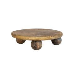 a wooden table with two wheels on it