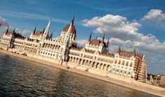 a large building sitting on the side of a river