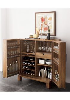 a wooden cabinet filled with lots of bottles and glasses