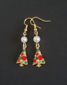 My absolute favorite new holiday earrings! These feature a gold Christmas tree with green and red crystals and small white pearls. I paired this with a simple lightweight pearl accent to create an elegant look. Ear hooks are nickel free! Holiday Jewelry Ideas, Crystal Christmas Tree, Large Stud Earrings, Crystal Christmas, Gold Holiday, Holiday Earrings, Gold Christmas Tree, Holiday Earring, Holiday Jewelry