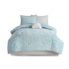 a blue comforter with white stars on it and a stuffed animal in the middle