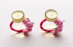 two rings with flowers and a candle on them