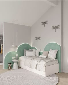 a white bed sitting in the middle of a bedroom next to a wall mounted clock