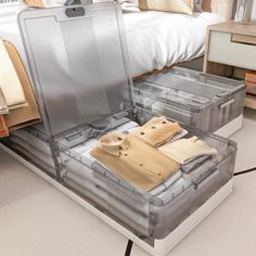 an open suitcase sitting on top of a bed