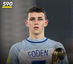 a young man holding a soccer ball and trophy