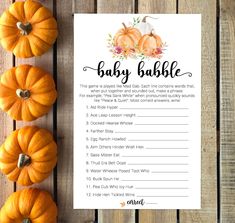 a baby shower game with pumpkins next to it