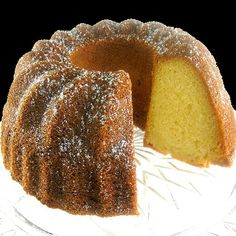 a bundt cake on a plate with one slice cut out