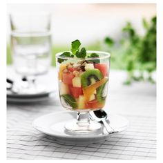 a fruit salad in a glass on a plate