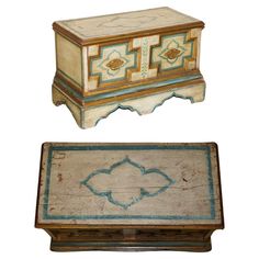 two wooden boxes with designs painted on the top and bottom, one has a lid