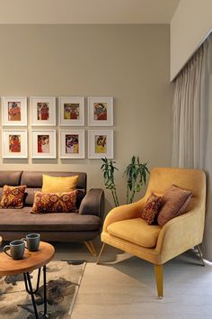 a living room filled with furniture and pictures on the wall