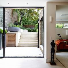 an open living room with stairs leading to the outside