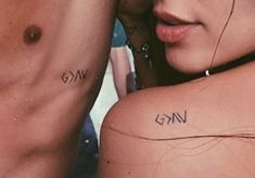 two people with small tattoos on their backs