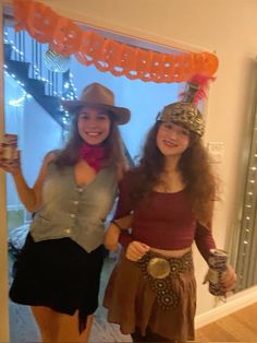 two women dressed up in costumes posing for the camera