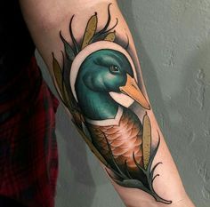 a tattoo with a bird on it's arm