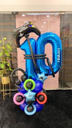 an inflatable balloon shaped like the number 20 with various colored balls and wheels