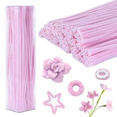 pink crochet hair accessories and flowers on a white background