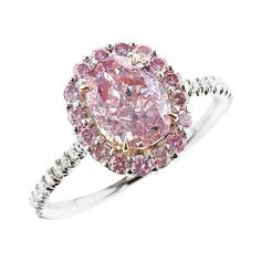 A beautiful and elegant ring centered with a natural oval-shape, Fancy Purplish Pink diamond, accented with a cluster of round brilliant-cut pink diamonds, with white round brilliant-cut diamonds along the shank. The center stone accompanies a gemological certificate from GIA stating the color as Fancy Purplish Pink, with natural and even color, stamped P950 and 750, size 6 1/2 US. Pink Diamond Halo Ring, Top Engagement Rings, Pink Engagement Ring, Pink Diamond Ring, Future Engagement Rings, Pink Diamonds, Platinum Diamond Engagement Rings, Handmade Engagement Rings, Pink Sapphire Ring