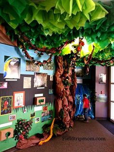 a classroom decorated with paper trees and pictures