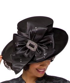 Giovanna Deluxe Church Hat Style: HG1103 Color: Black Elegant bow adorned hat featuring stone embellishment. Crown Circumference: 23" Chic Hats With Bow And Curved Brim, Elegant Winter Party Top Hat, Evening Hats With Bow And Short Brim, Kentucky Derby Party Hat With Satin Bow, Kentucky Derby Evening Hat With Satin Bow, Elegant Adjustable Black Cloche Hat, Elegant Hat With Satin Bow For Party, Winter Party Hats With Bow, Elegant Party Hat With Satin Bow