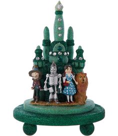 the wizard's castle figurine is made out of glitter and has three figures on it