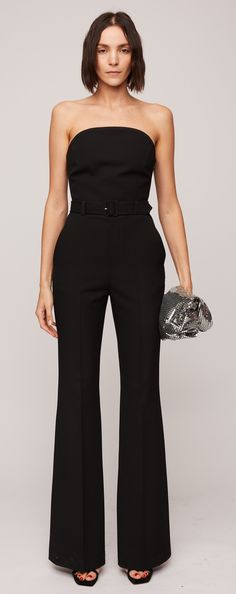 Crafted from our classic suiting material in a timeless black hue, the Kate Jumpsuit boasts a softly sculpted silhouette. It highlights flare legs and a strapless curved neckline with internal bone corsetry and a hook-and-eye panel for added structure and support along the bodice. Completing the ensemble are a belted waist and functional pockets for added convenience. Elegant Structured Pantsuit For Party, Sleek Structured Evening Pantsuit, Fitted Pantsuit With Structured Boning, Sleek Formal Pantsuit With Structured Boning, Structured Fitted Pantsuit For Party, Fitted Wide-leg Pantsuit With Belt Loops, Fitted Wide Leg Pantsuit With Belt Loops, Elegant Fitted Pants For Gala, Chic Structured Party Suits