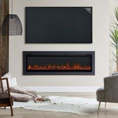 a living room with a couch, chair and television mounted on the wall in front of it