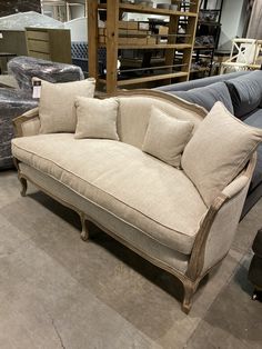 a couch with pillows on it in a store