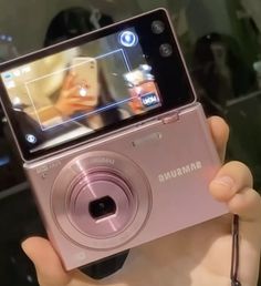 a person holding up a camera in their hand