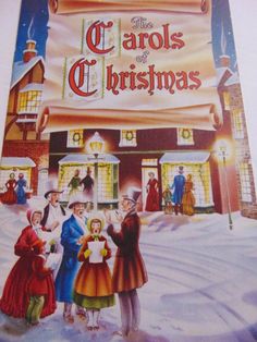 the carols of christmas book cover with children standing in front of a storefront