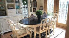 a dining room table with white chairs around it