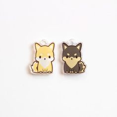 two pins with animals on them sitting next to each other in front of a white background