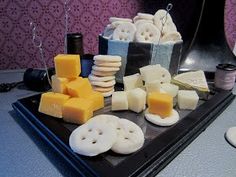 cheese and crackers are arranged on a tray