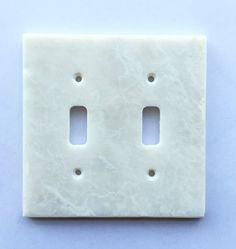 two light switch plates on a blue background