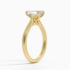 a yellow gold engagement ring with a pear shaped diamond