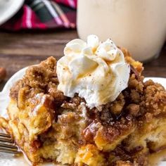 a slice of apple crumble cake on a white plate with a fork next to it