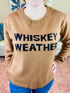 Embrace the season in our cozy brown knit sweater, featuring the chic phrase "Whiskey Weather" knitted in bold black lettering. This versatile piece is perfect for layering over jeans and sneakers for a relaxed, casual look, or dress it up with black pants and heels for a stylish night out. Whether you’re gathering around a bonfire or just enjoying a crisp evening, this sweater is your go-to for warmth and style. Brand: Panache ApparelDescription: Brown pullover with Whiskey Weather in black letteringFit Info: Runs True to Size, Whitney wears a SmallBust: The bust is looseWaist: The waist is looseHips: The hips are looseFabric: 100% AcrylicSize Reference: S: 2/4/6, M: 8/10, L: 12/14, XL: 16/18Whitney:Size: 4/6Bust 34CHeight 5'2Actual product colors may vary from the images shown due to dif Brown Letter Print Sweater For Winter, Casual Sweater With Graphic Print For Fall, Winter Knit Sweater With Letter Print, Winter Letter Print Knit Sweater, Brown Cotton Sweater With Graphic Print, Trendy Brown Crew Neck Sweater, Trendy Brown Cotton Sweater, Brown Graphic Print Cotton Sweater, Fall Graphic Print Knit Sweater