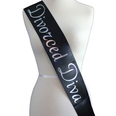 a white mannequin wearing a black and white ribbon with the words grace written on it