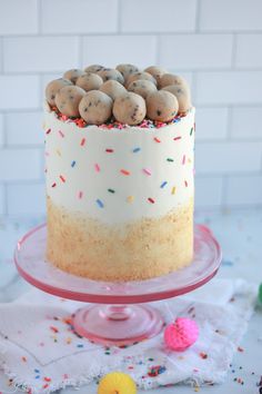 a cake with sprinkles and cookies on top