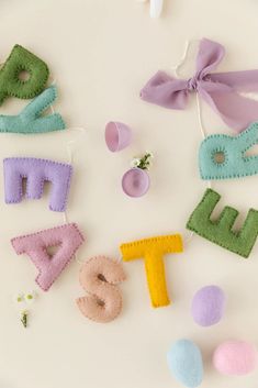 felt letters and decorations on a white surface