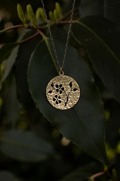 Delicate Brass Jewelry With Flower Pendant, Delicate Brass Flower Pendant Jewelry, Nature-inspired Brass Round Pendant Jewelry, Flower Shaped Hand Forged Jewelry Gift, Hand Forged Flower Jewelry Gift, Hand Forged Flower Shaped Jewelry Gift, Nature-inspired Hammered Gold Jewelry, Nature-inspired Gold Hammered Jewelry, Flower-shaped Bronze Brass Jewelry