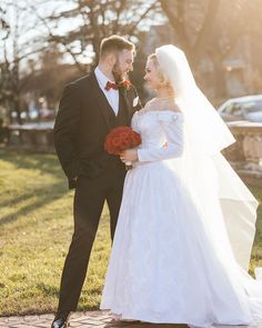 the bride and groom are standing together outside