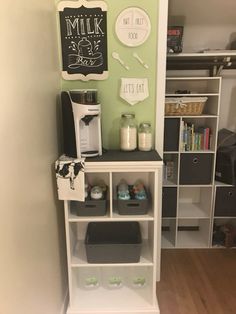 there is a coffee maker on top of the bookcase in this small kitchen area