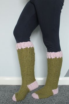 the legs of a woman wearing green and pink crocheted socks