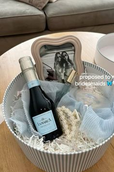 a bottle of wine sitting in a basket on top of a table