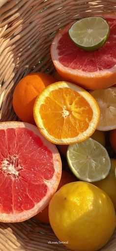 a basket filled with different types of citrus fruits