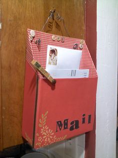 an open mailbox hanging from the side of a door with magnets on it