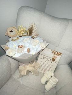 a teddy bear sitting on top of a white chair next to a bouquet of flowers